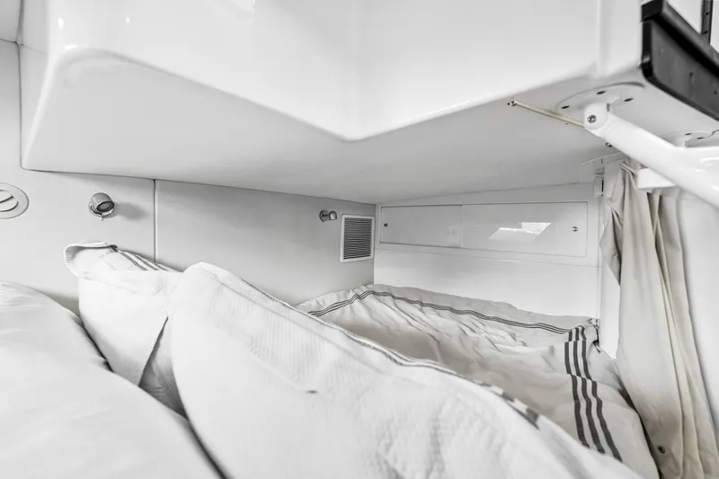  Yacht Photos Pics 2020 Intrepid 407 Cuddy cabin interior with cozy bedding and modern design.