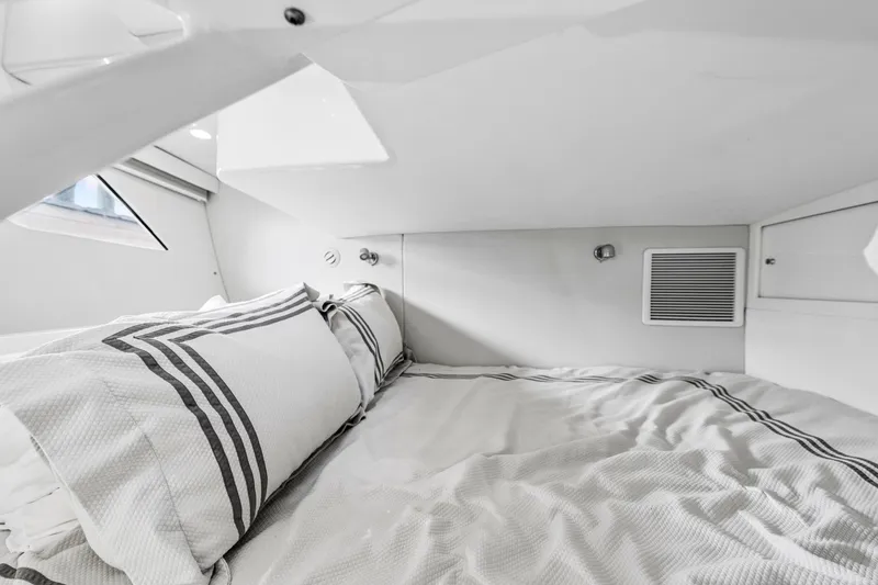  Yacht Photos Pics 2020 Intrepid 407 Cuddy cabin interior with cozy bedding and modern design.