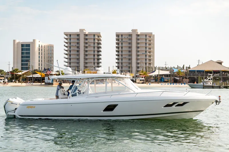  Yacht Photos Pics 2020 Intrepid 407 Cuddy boat on water with cityscape background.