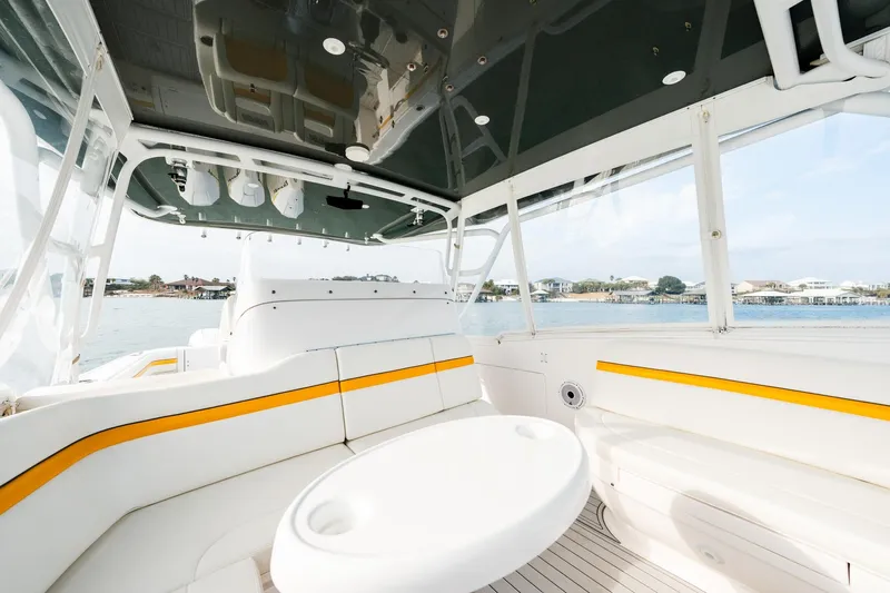  Yacht Photos Pics 2020 Intrepid 407 Cuddy boat interior with white seating and yellow accents.