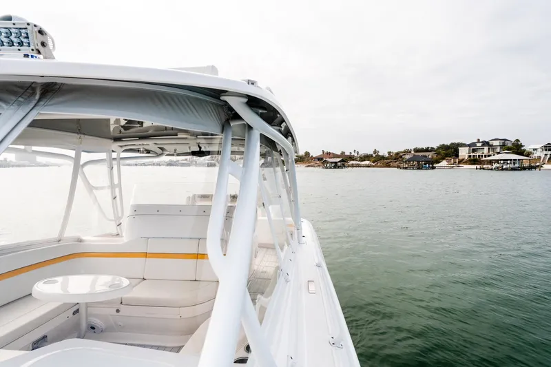  Yacht Photos Pics 2020 Intrepid 407 Cuddy boat cruising near waterfront homes on a calm day.