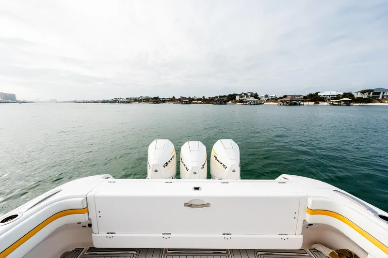  Yacht Photos Pics 2020 Intrepid 407 Cuddy boat with triple engines on calm water.