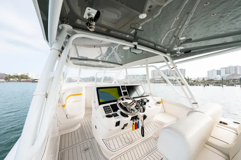 Yacht Photos Pics 2020 Intrepid 407 Cuddy boat interior with modern helm and waterfront view.