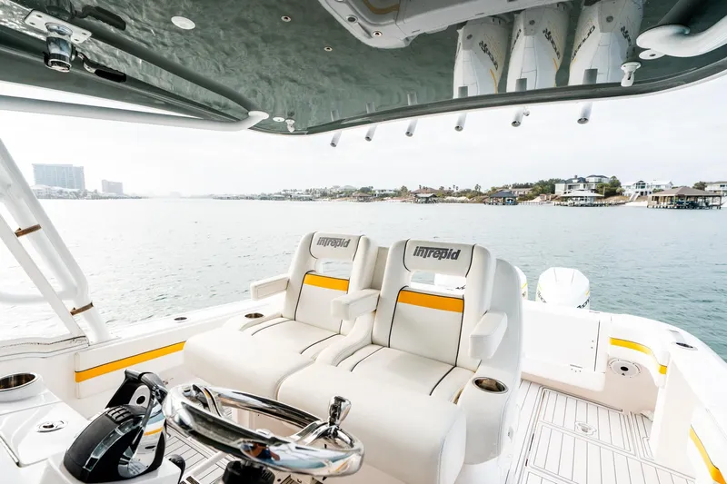  Yacht Photos Pics 2020 Intrepid 407 Cuddy boat interior with luxurious seating and scenic water view.