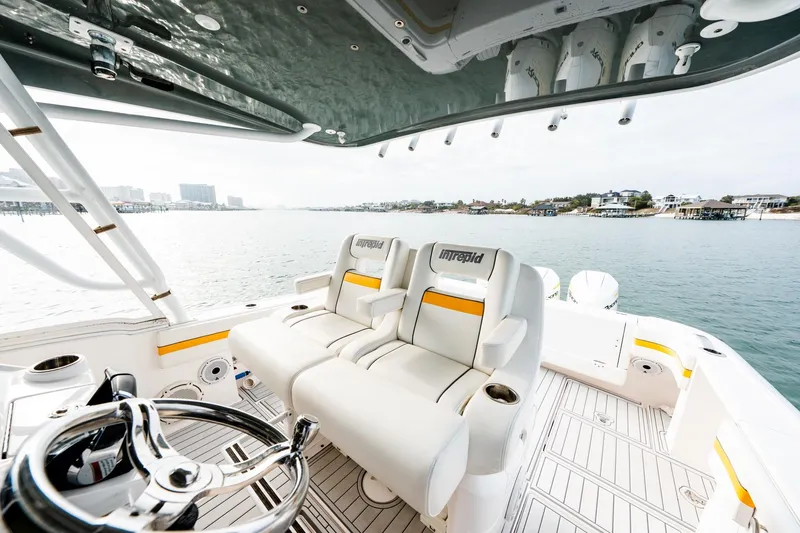  Yacht Photos Pics 2020 Intrepid 407 Cuddy boat interior with helm and seating, overlooking calm waters.