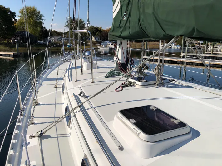 Volvamus Yacht Photos Pics Sailboat deck of 1995 Valiant 50, docked in a serene marina setting.