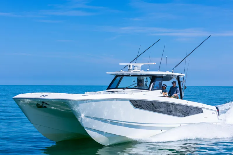  Yacht Photos Pics 2024 Aquila 47 Molokai cruising on clear blue ocean waters.