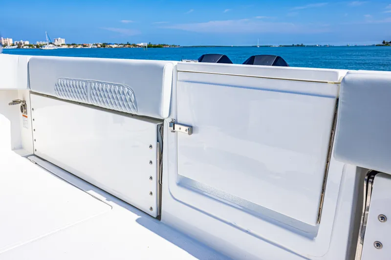  Yacht Photos Pics 2024 Aquila 47 Molokai yacht deck with storage compartments, overlooking serene blue waters.