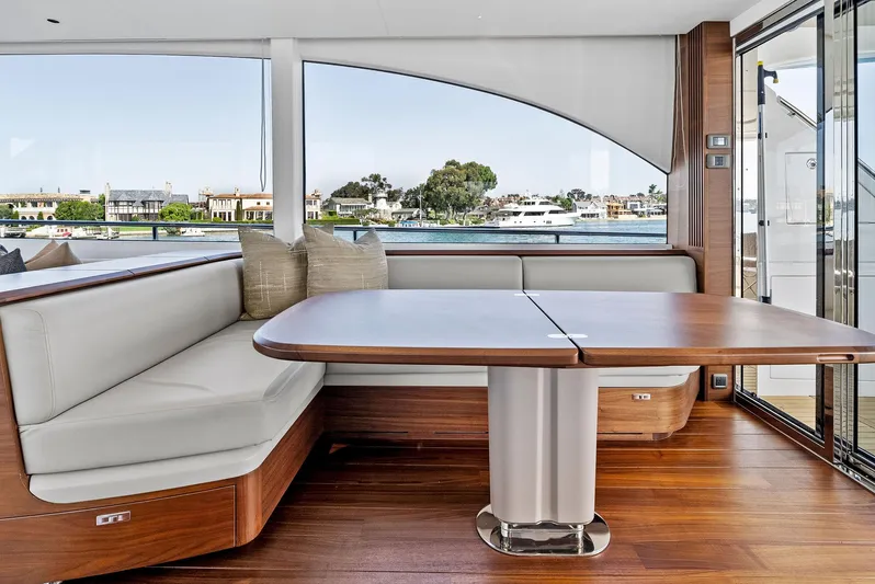 Robri Mar Yacht Photos Pics Luxurious interior of 2023 Princess Y72 yacht with elegant wood finishes and waterfront view.