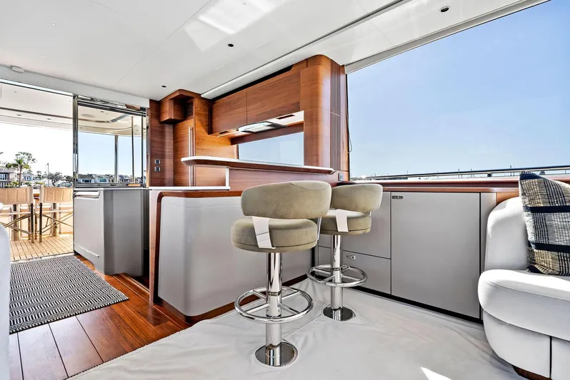 Robri Mar Yacht Photos Pics Luxurious interior of 2023 Princess Y72 yacht with modern kitchen and seating area.