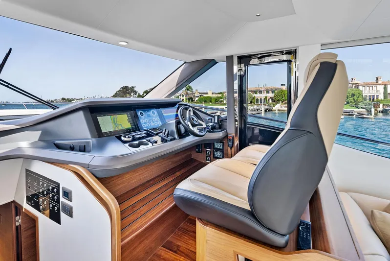 Robri Mar Yacht Photos Pics Luxurious 2023 Princess Y72 yacht cockpit with modern controls and waterfront view.