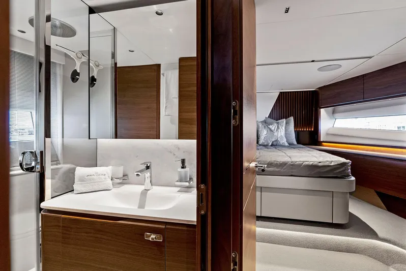 Robri Mar Yacht Photos Pics Luxurious interior of 2023 Princess Y72 yacht featuring a modern bathroom and cozy bedroom.