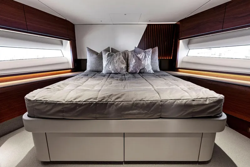 Robri Mar Yacht Photos Pics Luxurious bedroom interior of 2023 Princess Y72 yacht with modern design and elegant bedding.
