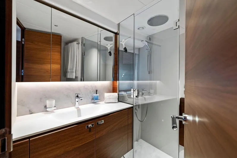 Robri Mar Yacht Photos Pics Luxurious bathroom in 2023 Princess Y72 yacht with modern fixtures and wooden cabinetry.