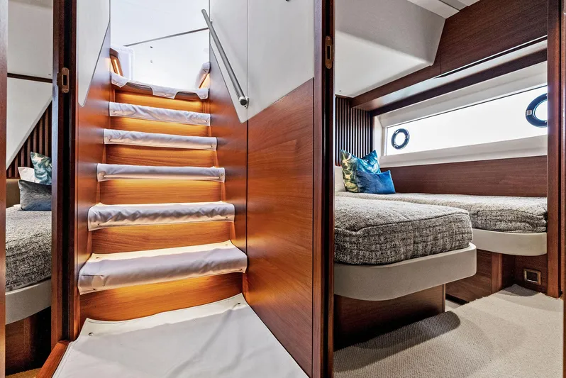 Robri Mar Yacht Photos Pics Luxurious interior of 2023 Princess Y72 yacht with elegant staircase and cozy bedroom.