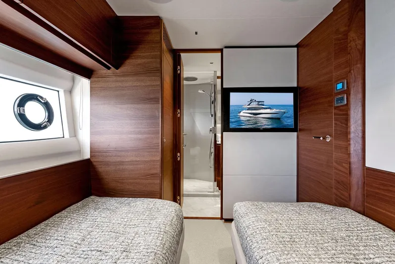 Robri Mar Yacht Photos Pics Luxurious 2023 Princess Y72 yacht cabin with twin beds and modern decor.