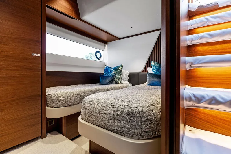 Robri Mar Yacht Photos Pics Luxurious 2023 Princess Y72 yacht cabin with twin beds and modern decor.
