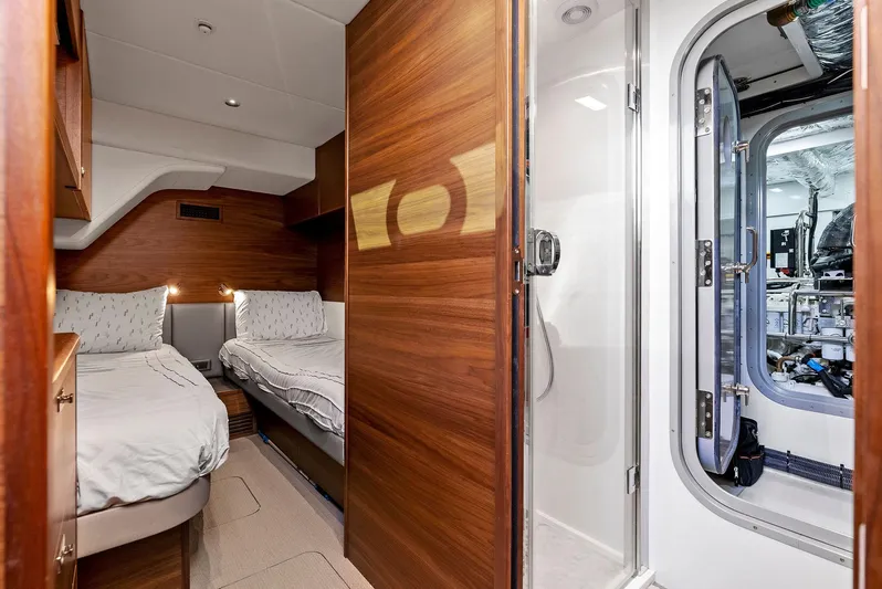Robri Mar Yacht Photos Pics Luxurious 2023 Princess Y72 yacht cabin with twin beds and modern bathroom.
