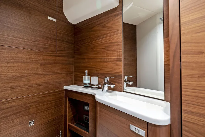 Robri Mar Yacht Photos Pics Luxurious bathroom in 2023 Princess Y72 yacht with wood paneling and modern fixtures.