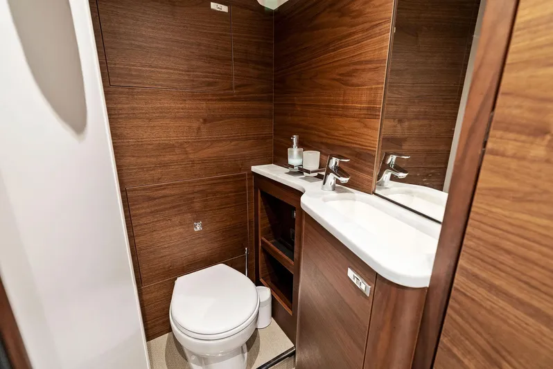 Robri Mar Yacht Photos Pics Luxurious bathroom in 2023 Princess Y72 yacht with wood paneling and modern fixtures.