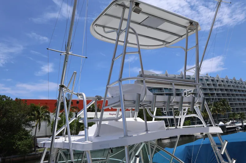 Geranomo Yacht Photos Pics 2007 Luhrs 32 Open boat with a flybridge, docked near modern buildings.