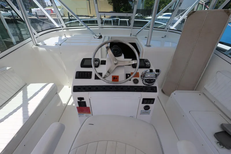 Geranomo Yacht Photos Pics 2007 Luhrs 32 Open boat helm station with steering wheel and control panel.