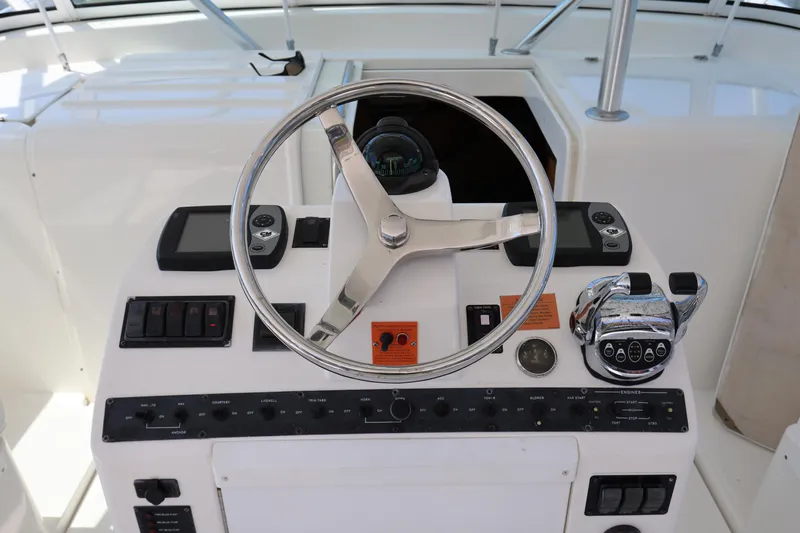 Geranomo Yacht Photos Pics 2007 Luhrs 32 Open boat helm with steering wheel and control panel.