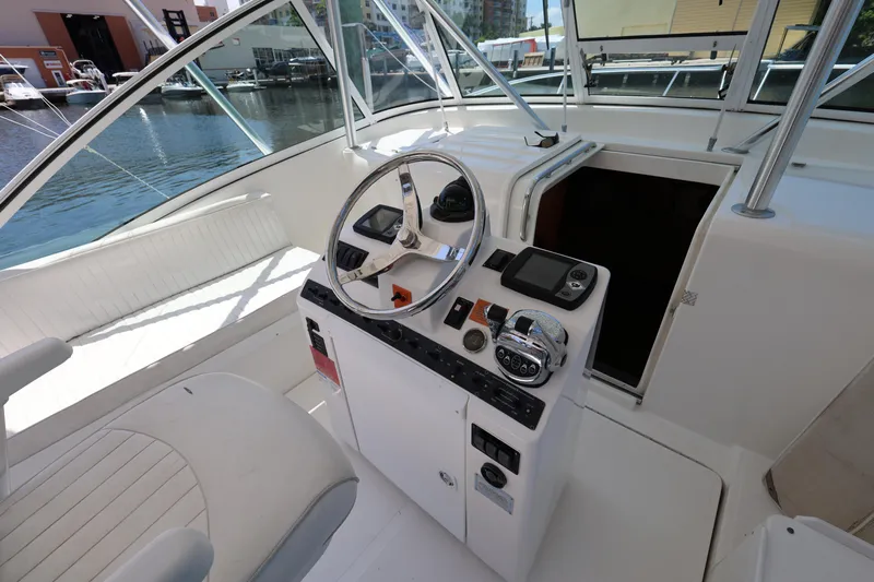 Geranomo Yacht Photos Pics 2007 Luhrs 32 Open boat helm station with steering wheel and controls.