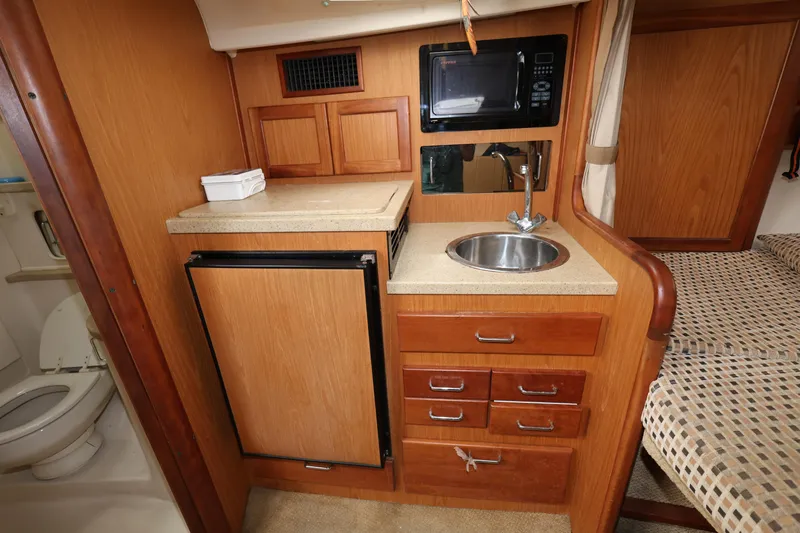 Geranomo Yacht Photos Pics 2007 Luhrs 32 Open galley with sink, microwave, fridge, and storage drawers.