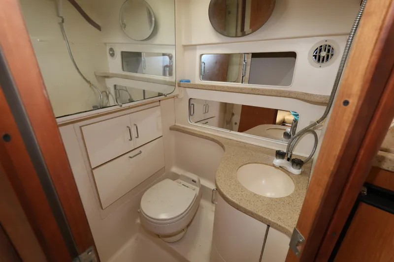 Geranomo Yacht Photos Pics 2007 Luhrs 32 Open yacht bathroom with sink, toilet, and storage cabinets.