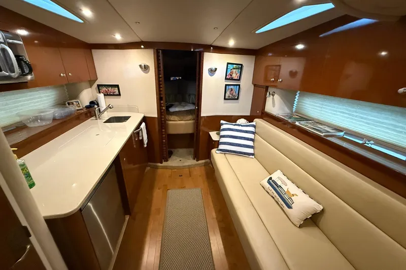  Yacht Photos Pics Interior of 2009 Sea Ray 350 Sundancer yacht with modern kitchen and cozy seating area.
