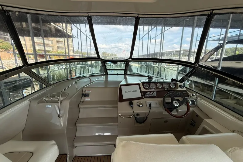  Yacht Photos Pics 2009 Sea Ray 350 Sundancer helm with Garmin navigation, docked in a marina.