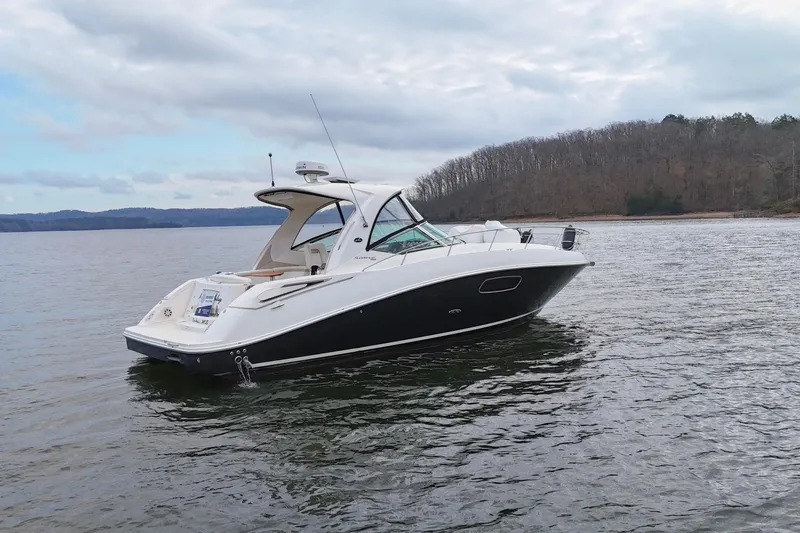  Yacht Photos Pics 2009 Sea Ray Sundancer 350 yacht on calm lake with wooded shoreline.