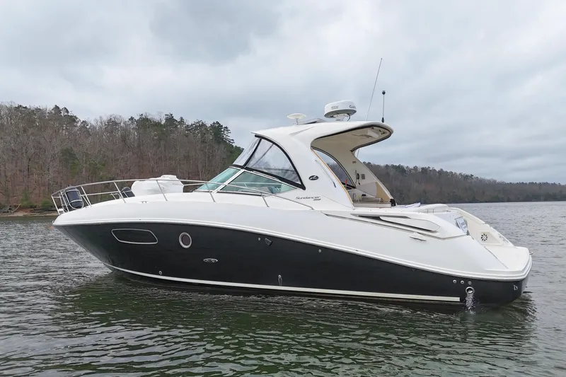  Yacht Photos Pics 2009 Sea Ray Sundancer 350 yacht on a serene lake with wooded shoreline.