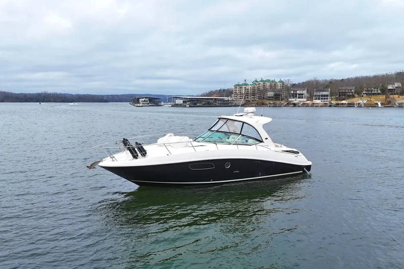  Yacht Photos Pics 2009 Sea Ray Sundancer 350 yacht on a calm lake with scenic shoreline.