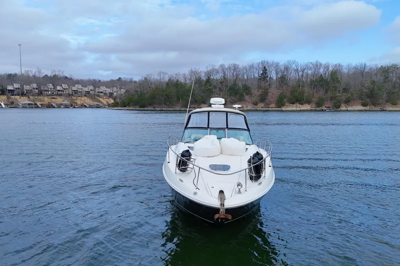  Yacht Photos Pics 2009 Sea Ray Sundancer 350 yacht on a calm lake with wooded shoreline.