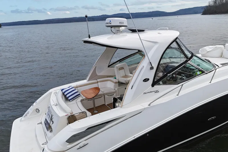  Yacht Photos Pics 2009 Sea Ray Sundancer 350 yacht on calm lake with scenic background.