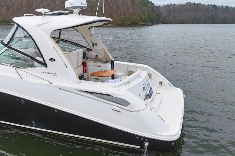  Yacht Photos Pics 2009 Sea Ray Sundancer 350 yacht on a serene lake with wooded shoreline.