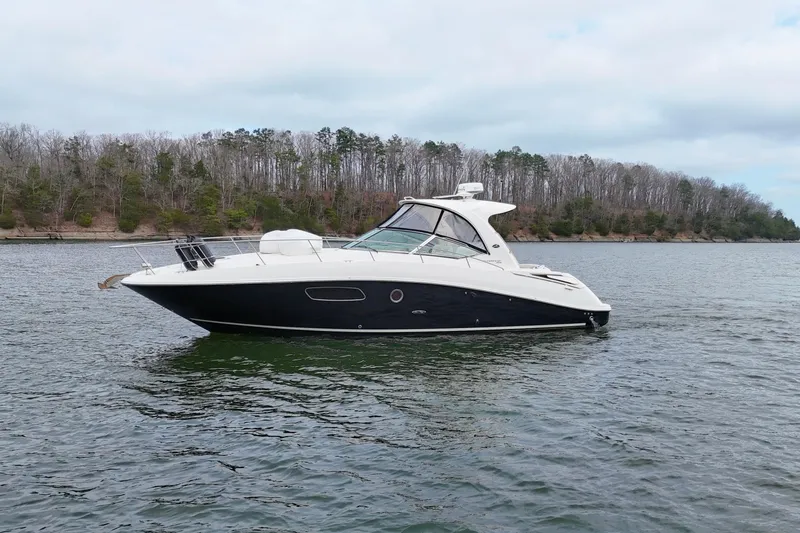  Yacht Photos Pics 2009 Sea Ray Sundancer 350 yacht on a calm lake with wooded shoreline.