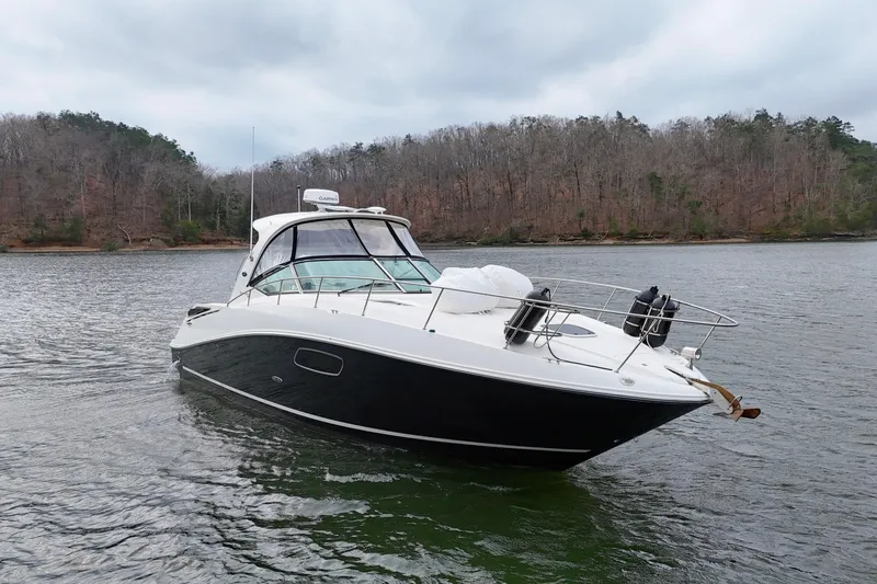  Yacht Photos Pics 2009 Sea Ray Sundancer 350 yacht on a calm lake with forested shoreline.