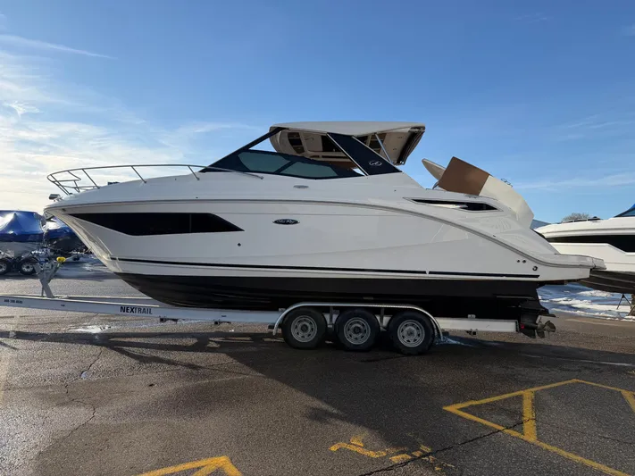  Yacht Photos Pics 2019 Sea Ray 320 Sundancer on a trailer outdoors.