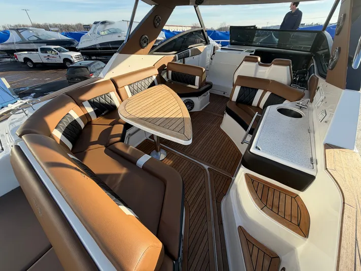  Yacht Photos Pics Interior of 2019 Sea Ray 320 Sundancer with luxurious seating and table.