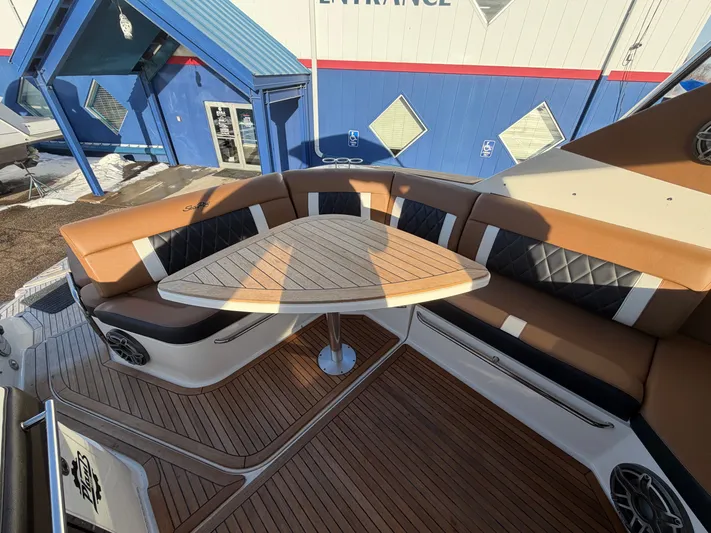  Yacht Photos Pics Interior of 2019 Sea Ray 320 Sundancer with wooden table and cushioned seating.