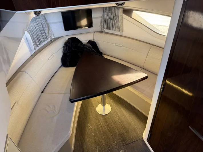  Yacht Photos Pics Interior of 2019 Sea Ray 320 Sundancer with seating area and table.