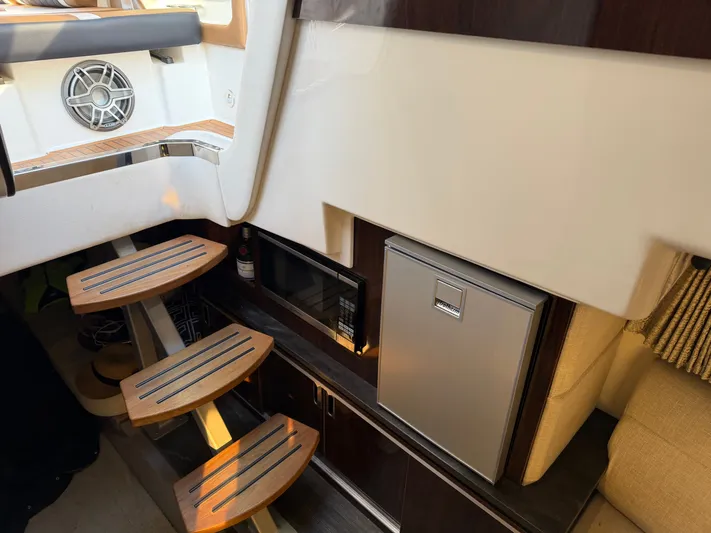  Yacht Photos Pics Interior of 2019 Sea Ray 320 Sundancer with stairs and fridge.
