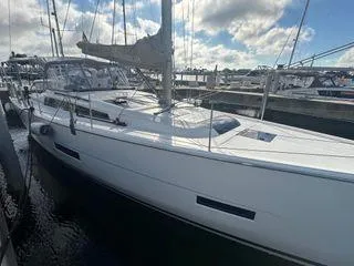 Epiphany Yacht Photos Pics 2022 Dufour 430 sailboat docked at marina under cloudy sky.