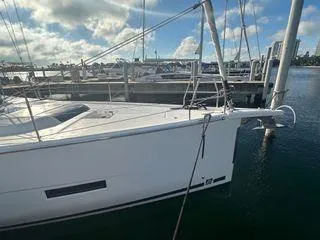 Epiphany Yacht Photos Pics 2022 Dufour 430 yacht docked at marina under a partly cloudy sky.