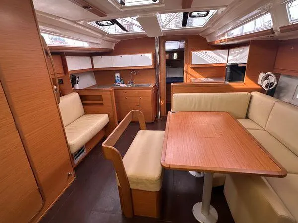 Epiphany Yacht Photos Pics Interior of 2022 Dufour 430 yacht with wooden furnishings and cozy seating area.