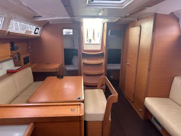 Epiphany Yacht Photos Pics Interior of 2022 Dufour 430 yacht, featuring wooden furnishings and cozy seating area.