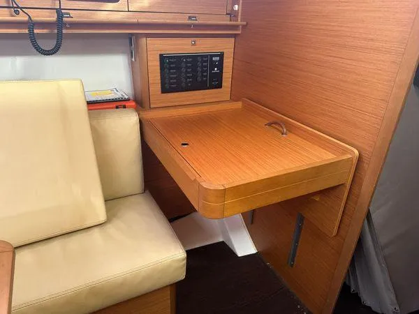 Epiphany Yacht Photos Pics Interior of 2022 Dufour 430 yacht with wooden desk and beige seating.